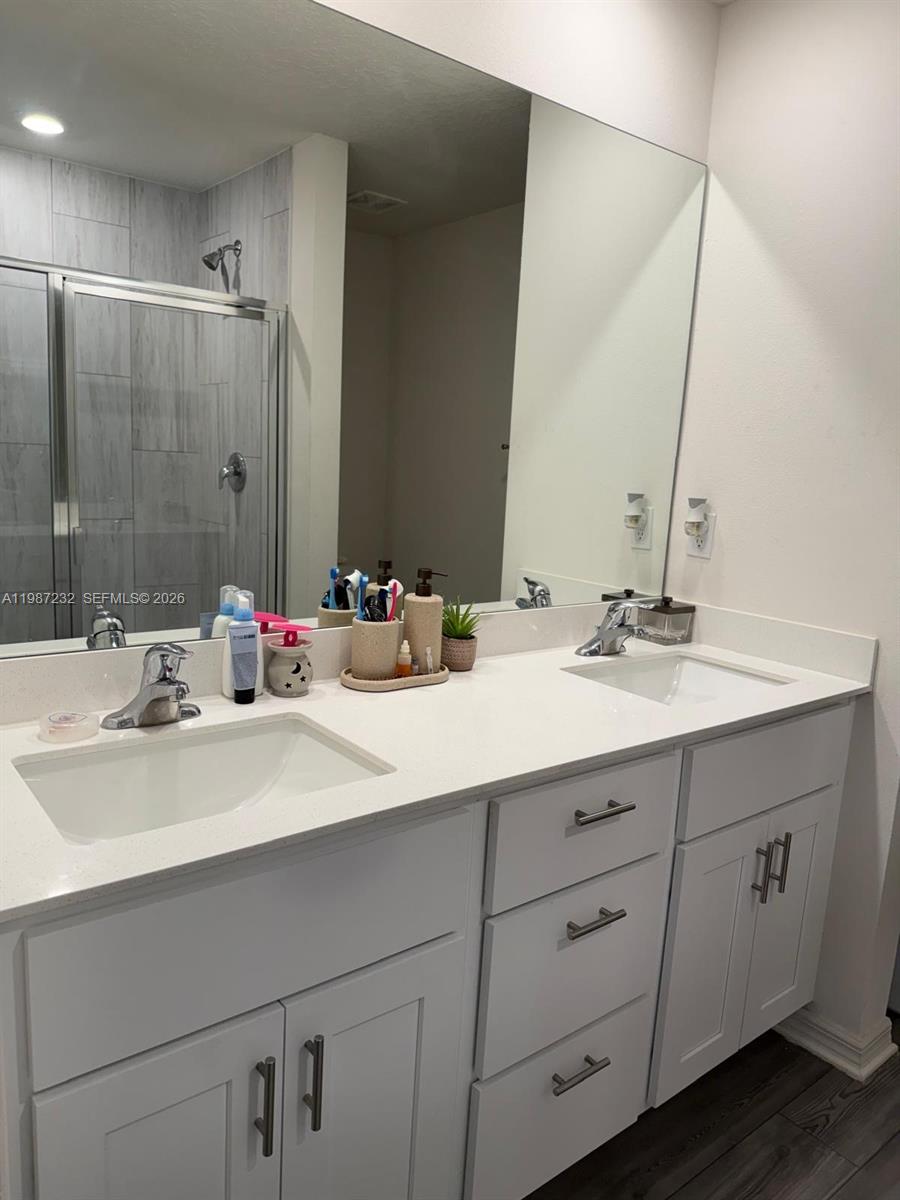 3902 Southwest Brunswick Street Port St. Lucie, FL 34953 - Photo 18 of 23 a bathroom with double sink and a mirror