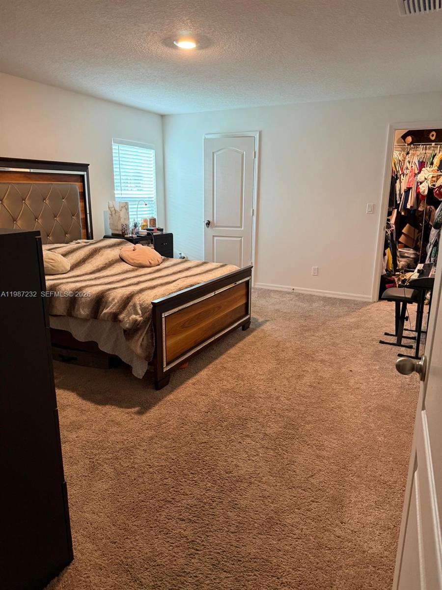 3902 Southwest Brunswick Street Port St. Lucie, FL 34953 - Photo 20 of 23 a bedroom with a bed and closet