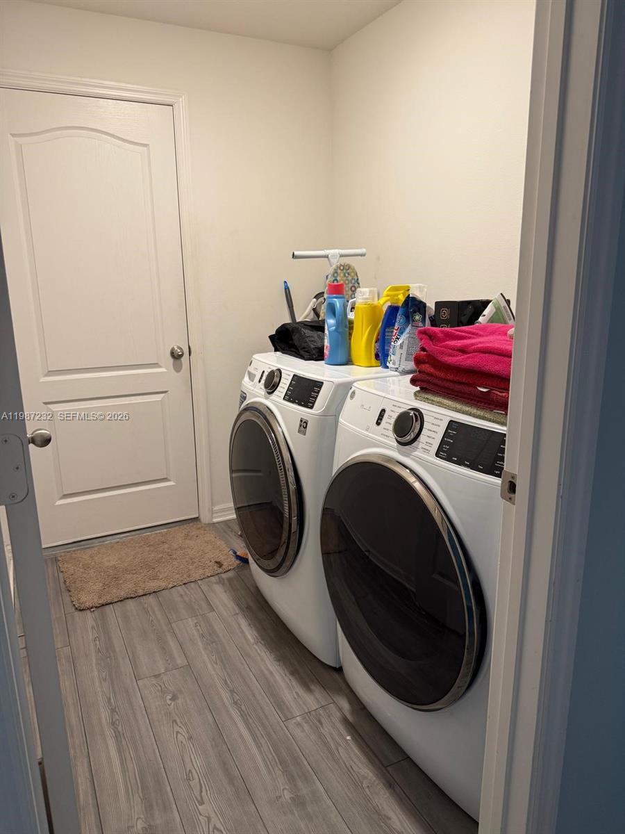 3902 Southwest Brunswick Street Port St. Lucie, FL 34953 - Photo 2 of 23 a utility room with dryer and washer