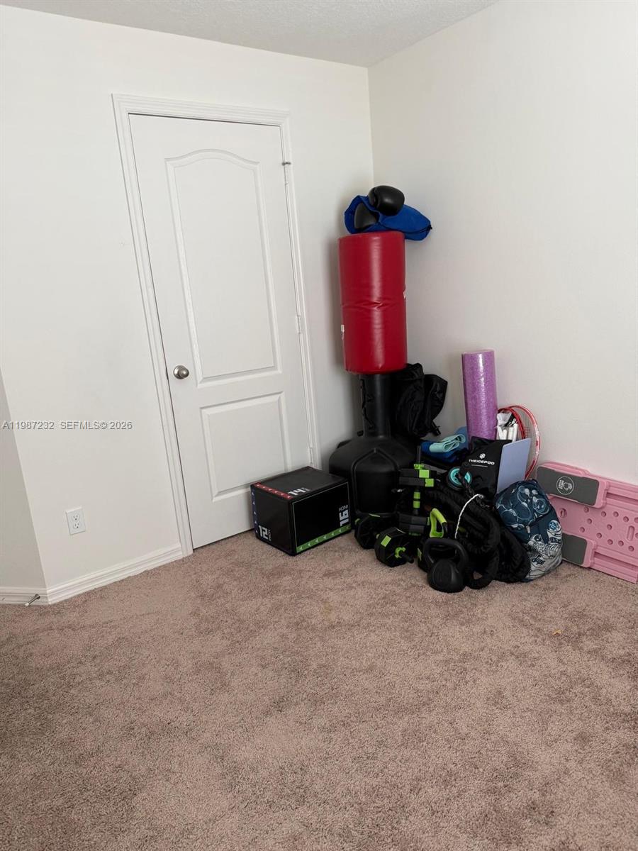 3902 Southwest Brunswick Street Port St. Lucie, FL 34953 - Photo 22 of 23 a room with furniture and a potted plant