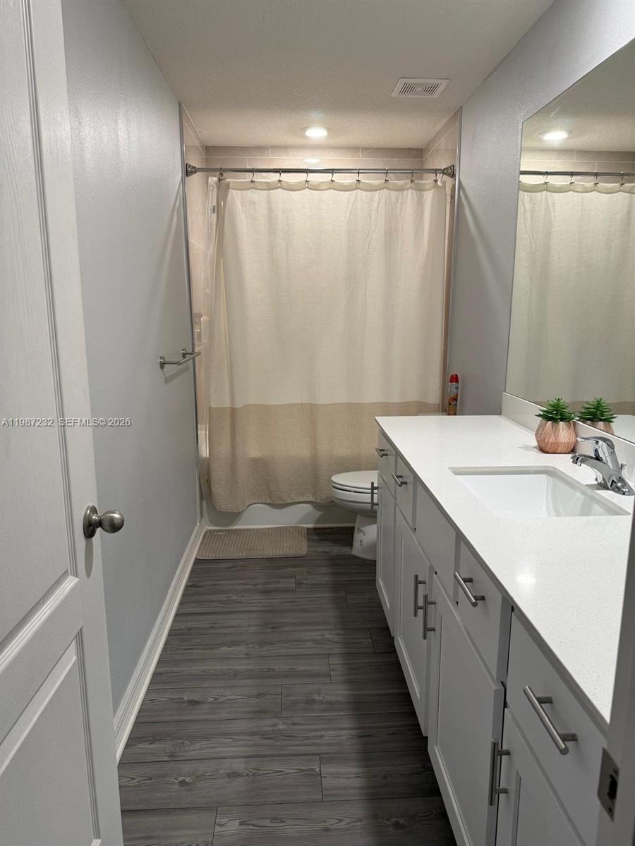 3902 Southwest Brunswick Street Port St. Lucie, FL 34953 - Photo 4 of 23 a bathroom with a double vanity sink and a mirror