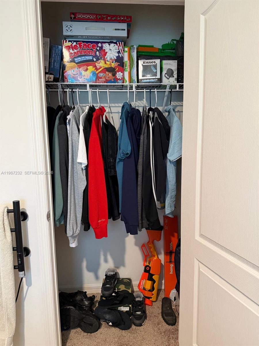 3902 Southwest Brunswick Street Port St. Lucie, FL 34953 - Photo 6 of 23 a view of walk in closet with clothes and shoes