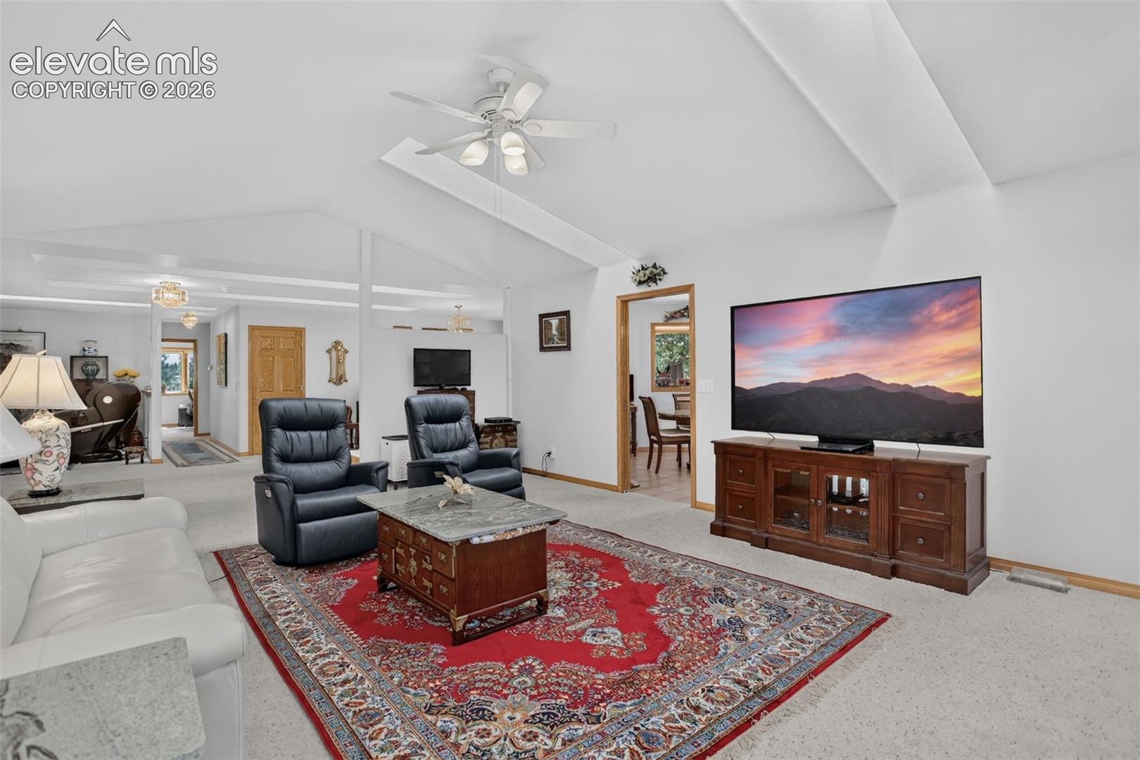 11570 Milford Road Elbert, CO 80106 - Photo 22 of 49 Family room with open layout to kitchen, dining, and formal living room.