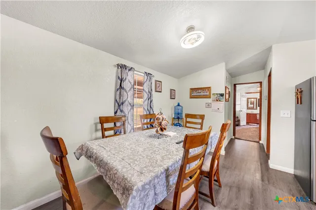a dining room with furniture and wooden floor