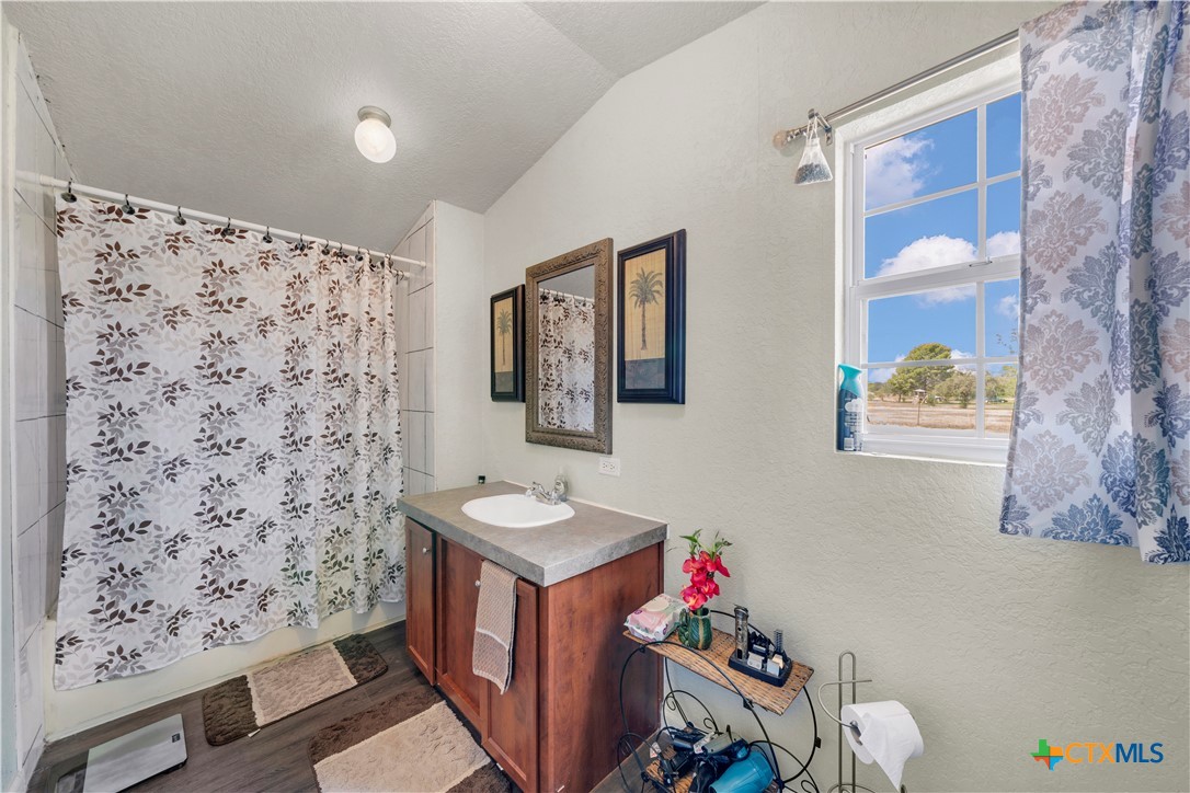 11791 Kinney Road Atascosa, TX 78002 - Photo 17 of 20 a bathroom with a sink toilet and a shower