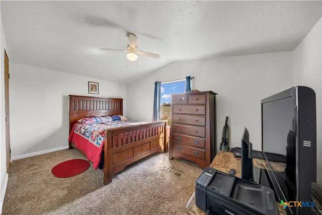 a bedroom with furniture and a flat screen tv