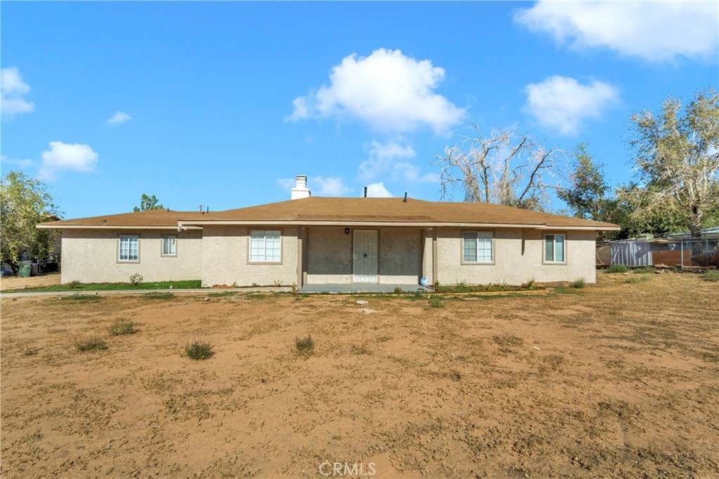 21424 Rancherias Road Apple Valley, CA 92307 - Photo 1 of 1 a large house with a big yard and large trees