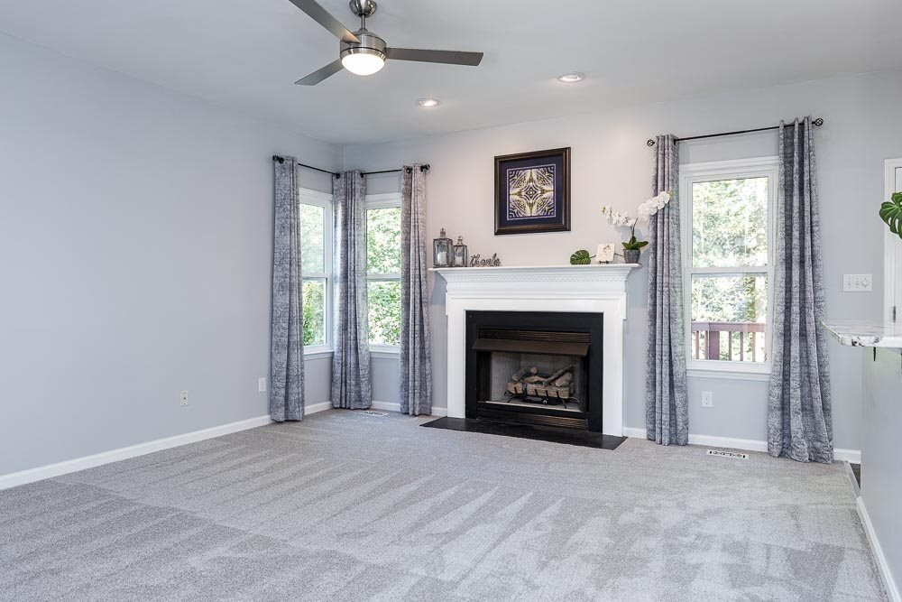 12212 Amoretto Way Raleigh, NC 27613 - Photo 13 of 30 Envision the gas logs blazing as you look out over the snow falling in your landscaped yard! Family Room