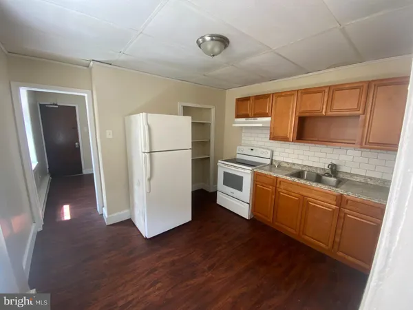 a kitchen with a refrigerator sink and cabinets