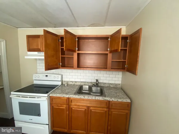 a kitchen with a sink stove and refrigerator