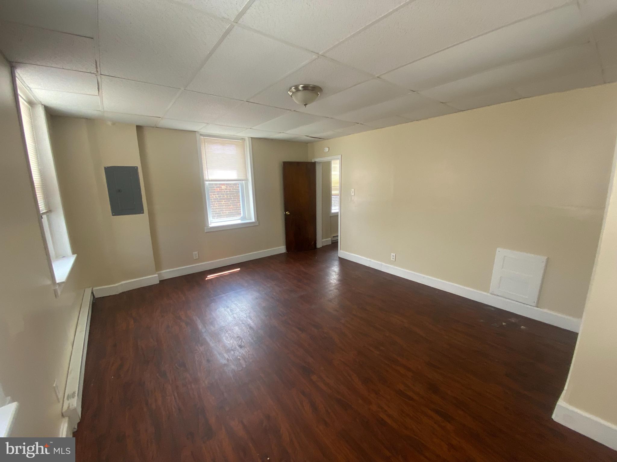 432 North 64th Street, Unit 2F Philadelphia, PA 19151 - Photo 5 of 7 an empty room with wooden floor and windows