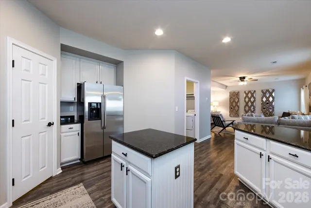 a kitchen with a refrigerator and a sink