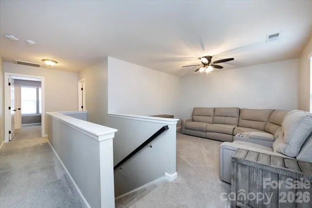 a living room with furniture and white walls