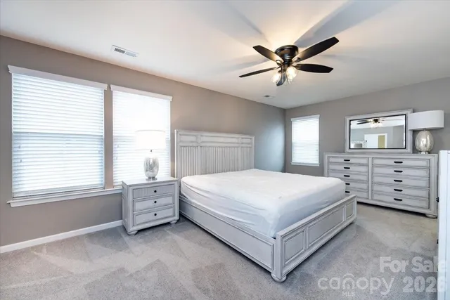 a spacious bedroom with a large bed and a window