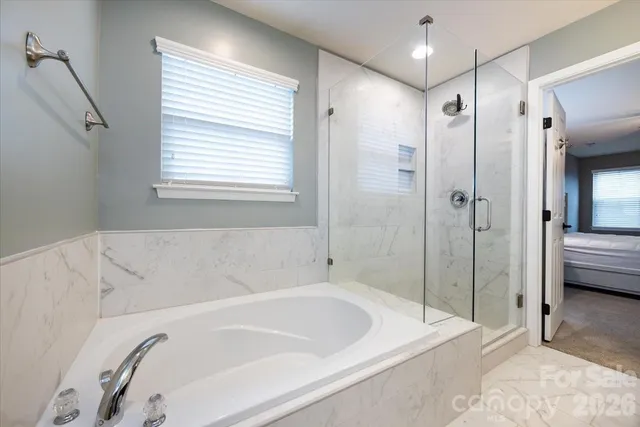 a bathroom with a bathtub and a shower