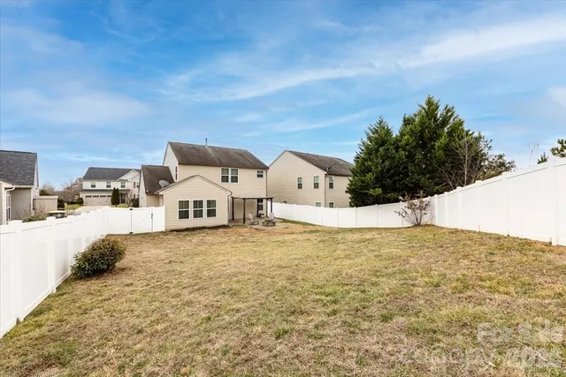 a view of white house with a yard