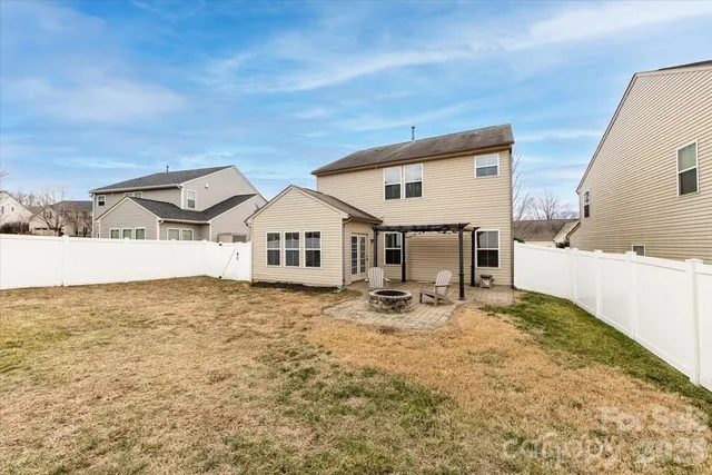 a view of a house with wooden fence