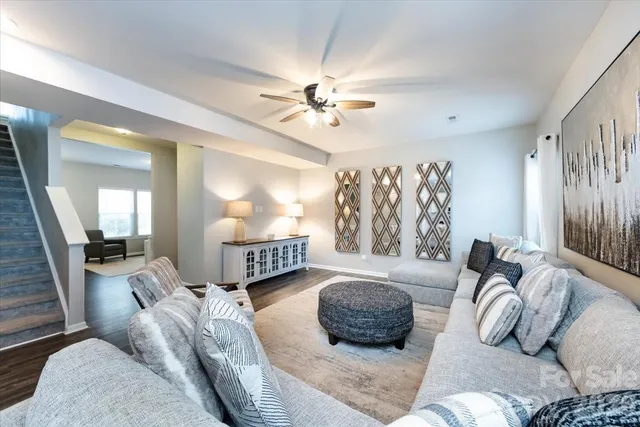 a bedroom with furniture and a large window