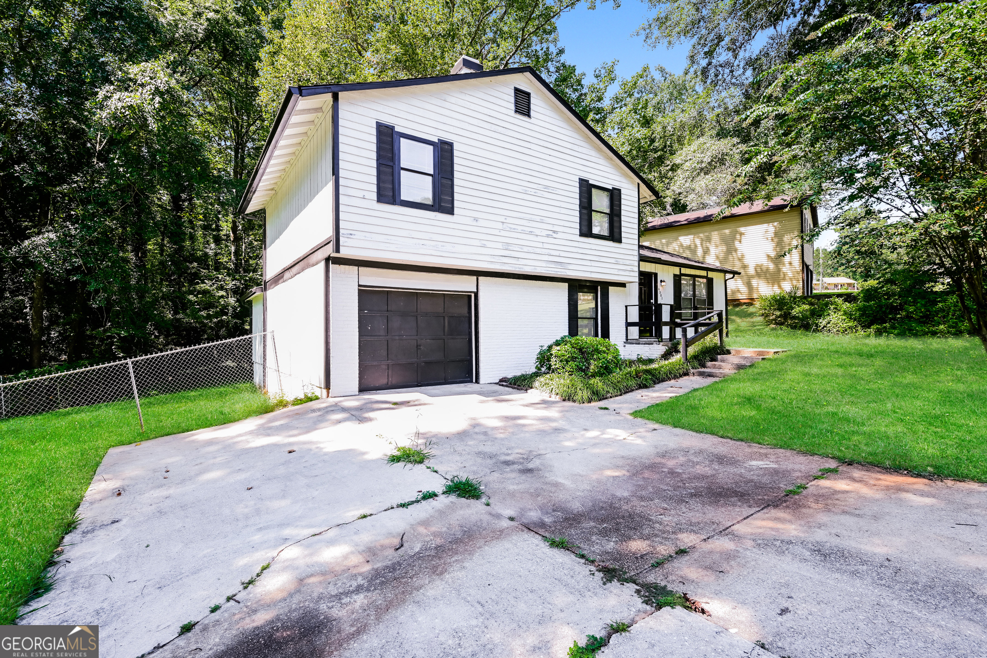 4301 Dogwood Farms Drive Decatur, GA 30034 - Photo 2 of 22 a view of a white house with a yard and large trees