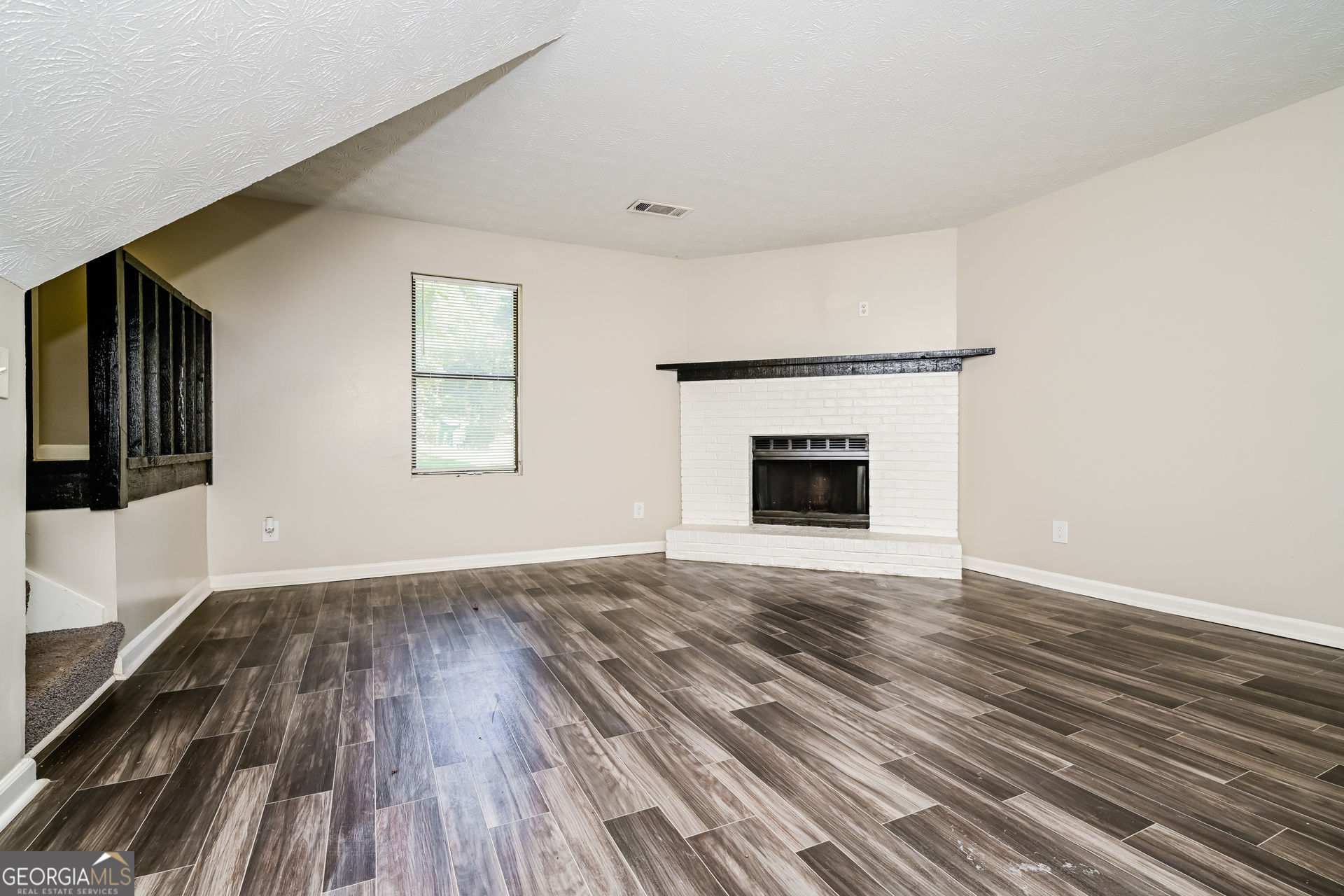 4301 Dogwood Farms Drive Decatur, GA 30034 - Photo 5 of 22 a view of an empty room with wooden floor and a window