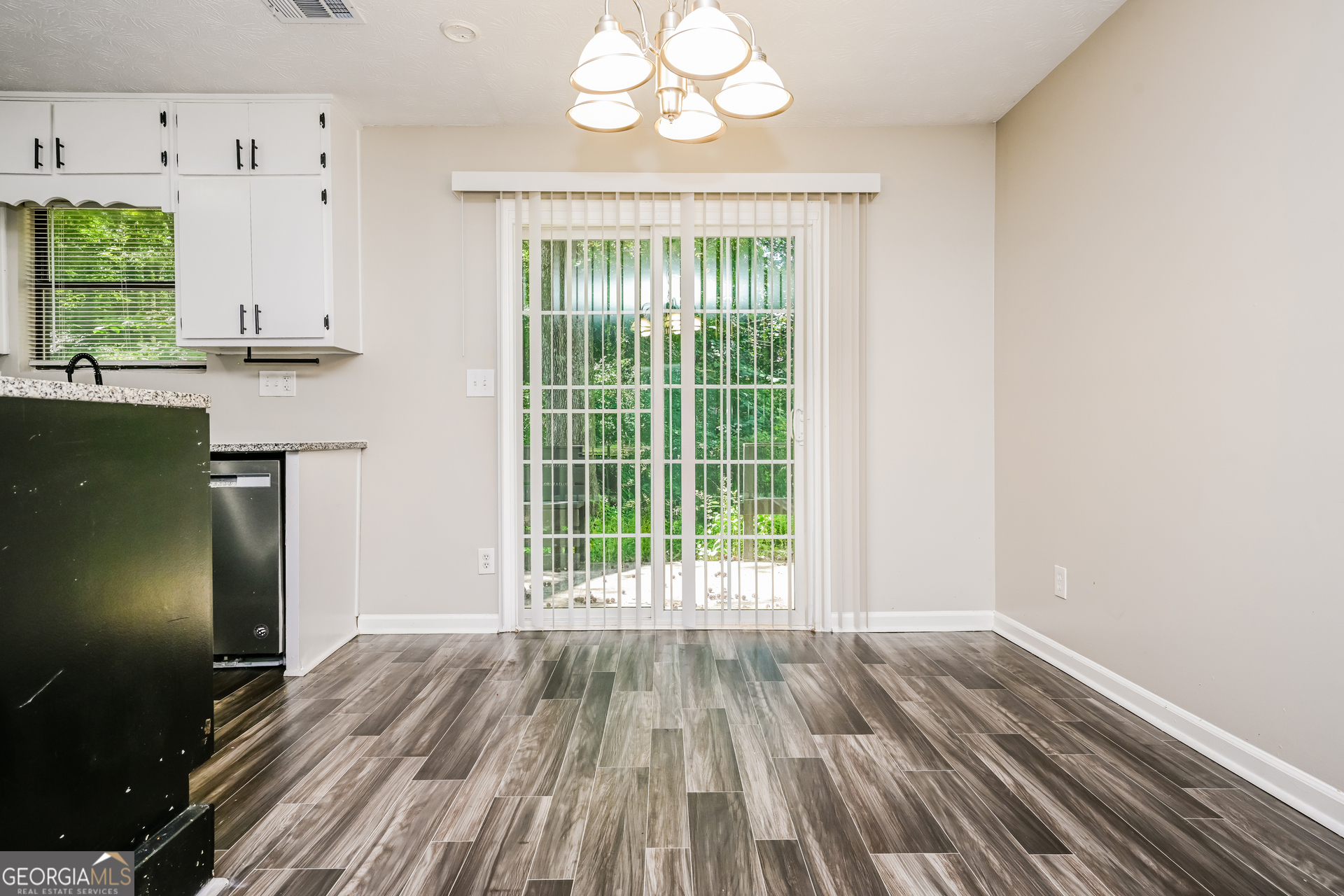 4301 Dogwood Farms Drive Decatur, GA 30034 - Photo 6 of 22 a view of an empty room with wooden floor and a window