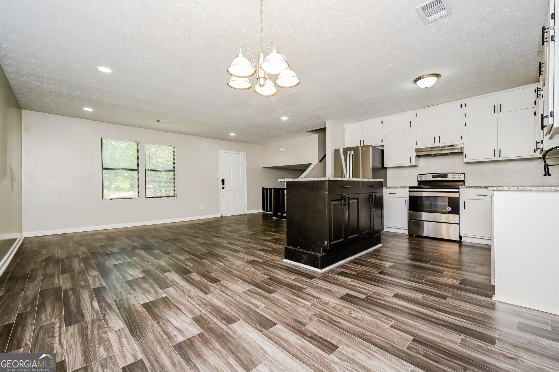 4301 Dogwood Farms Drive Decatur, GA 30034 - Photo 7 of 22 a kitchen with kitchen island granite countertop a stove and a sink