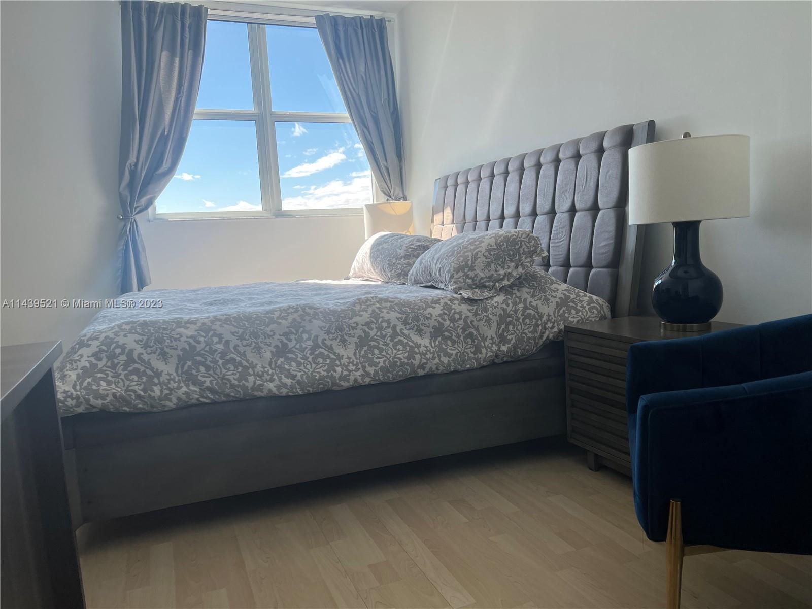 2475 Brickell Avenue, Unit 1509 Miami, FL 33129 - Photo 11 of 18 a bedroom with a bed and a window with outer view