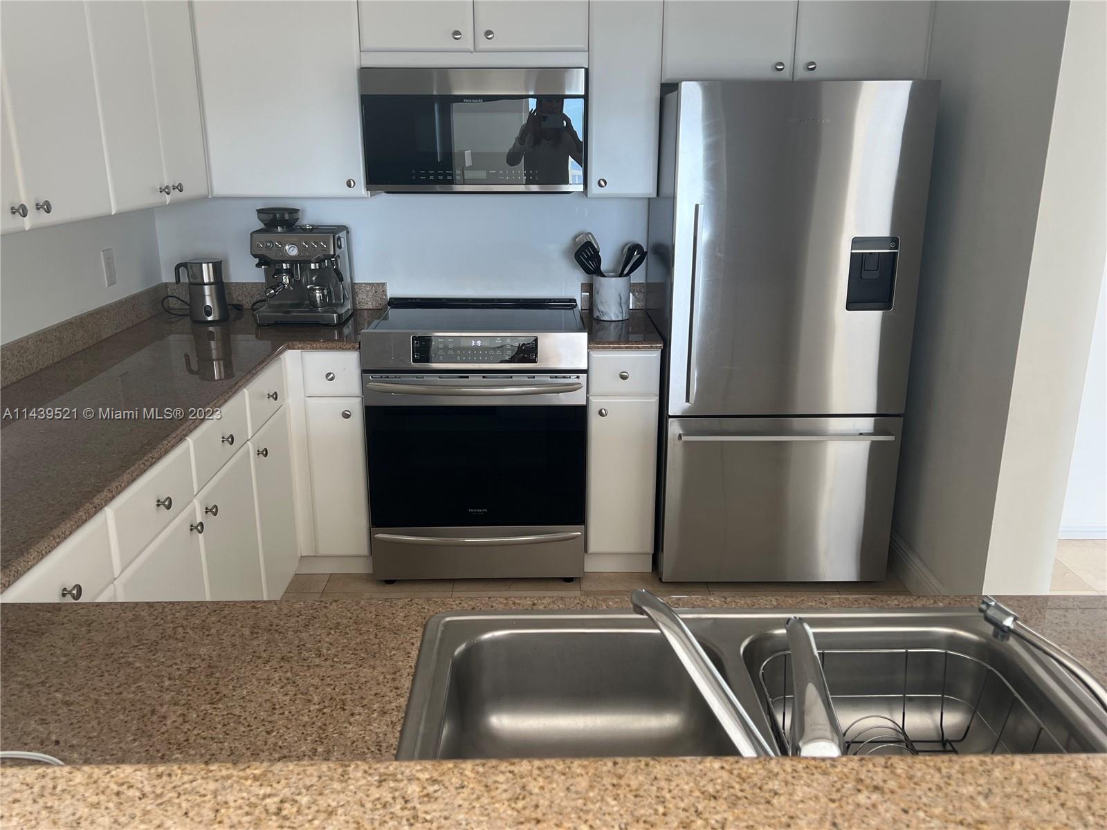 2475 Brickell Avenue, Unit 1509 Miami, FL 33129 - Photo 14 of 18 a kitchen with a refrigerator sink and stove