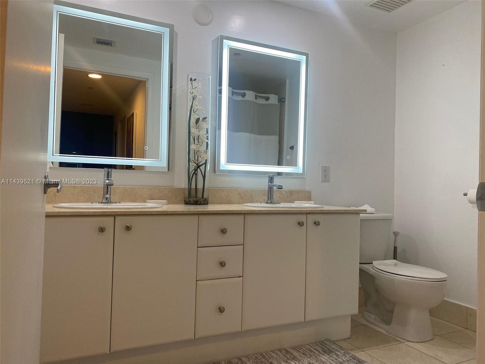2475 Brickell Avenue, Unit 1509 Miami, FL 33129 - Photo 15 of 18 a bathroom with a toilet sink and mirror