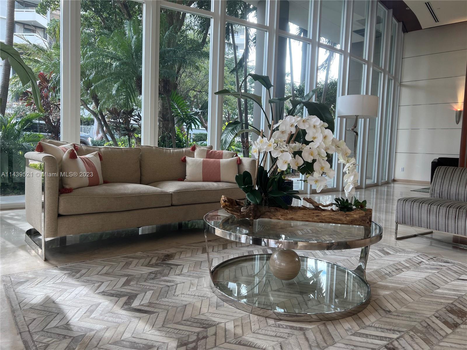 2475 Brickell Avenue, Unit 1509 Miami, FL 33129 - Photo 2 of 18 a living room with furniture and a fountain