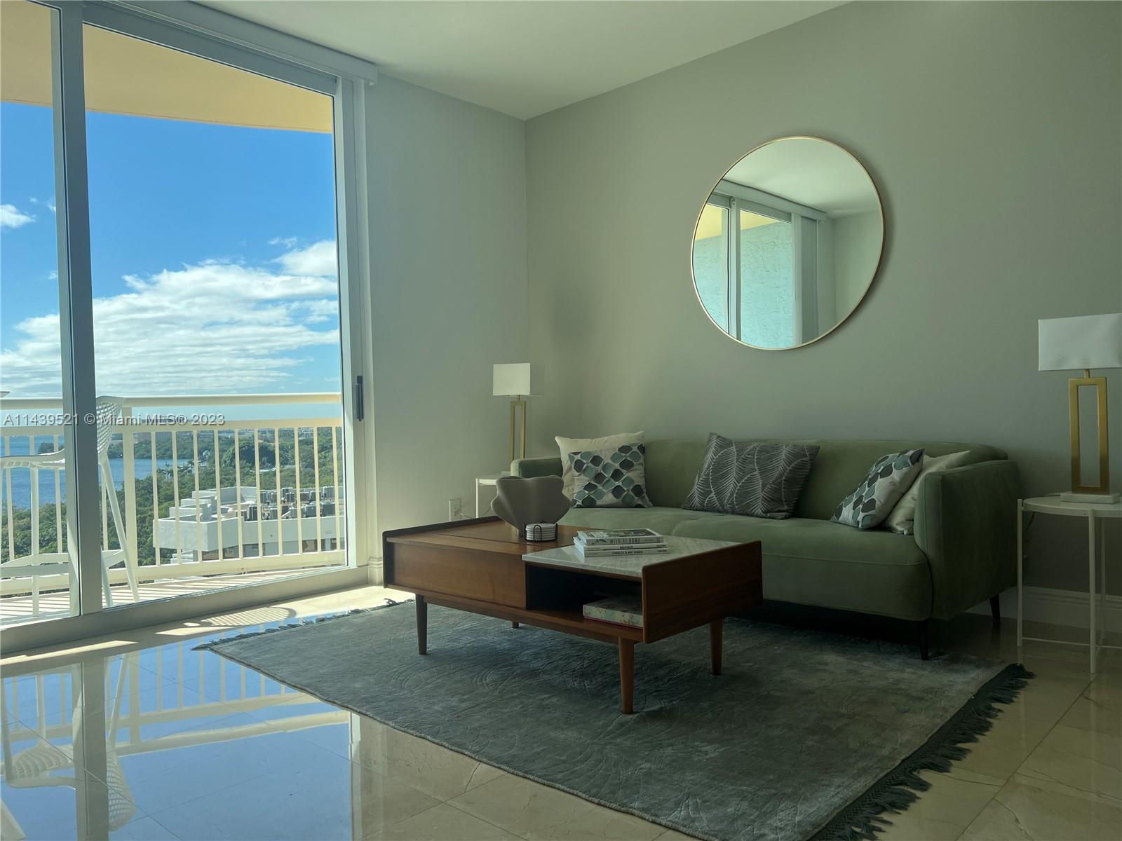 2475 Brickell Avenue, Unit 1509 Miami, FL 33129 - Photo 8 of 18 a living room with furniture and a large window