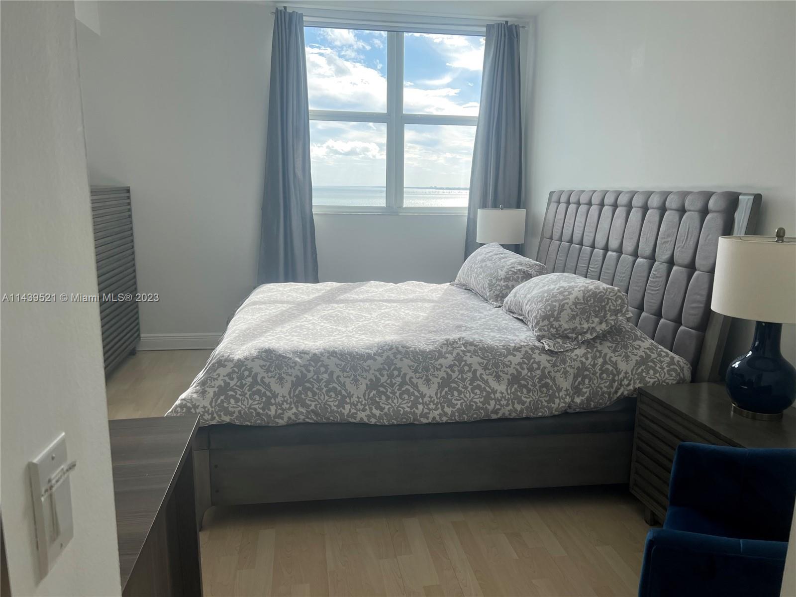 2475 Brickell Avenue, Unit 1509 Miami, FL 33129 - Photo 10 of 18 a bedroom with a bed and a window