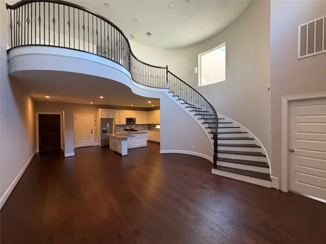 a view of entryway livingroom and hall with wooden floor