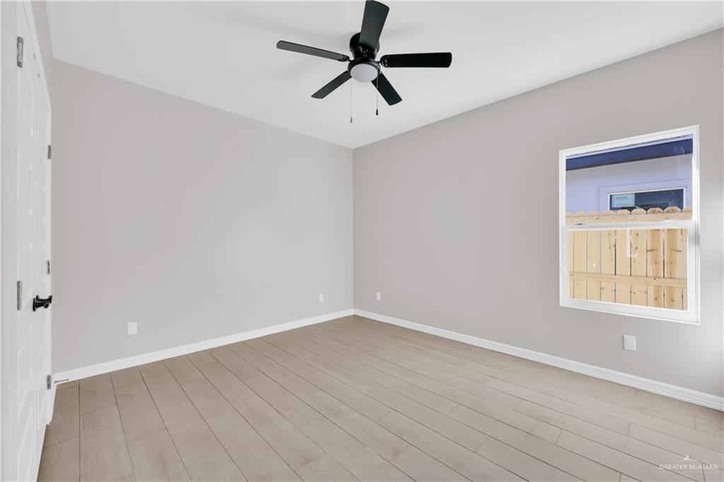 913 West 13th Street, Unit 3 San Juan, TX 78589 - Photo 12 of 14 an empty room with a window and a ceiling fan