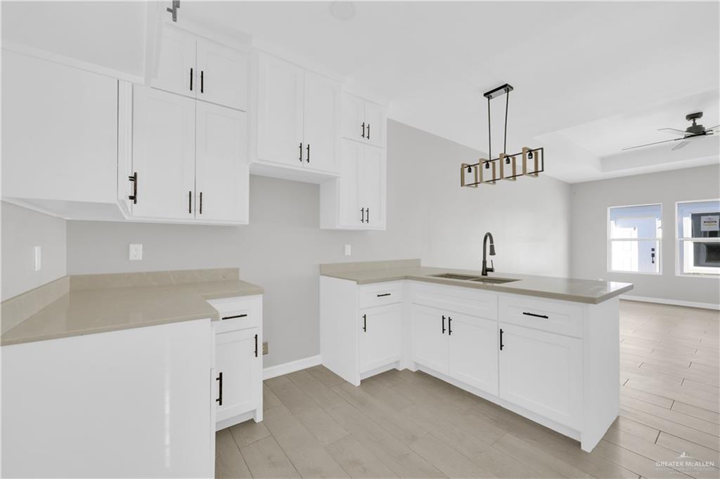 913 West 13th Street, Unit 3 San Juan, TX 78589 - Photo 6 of 14 a kitchen with granite countertop white cabinets and a sink