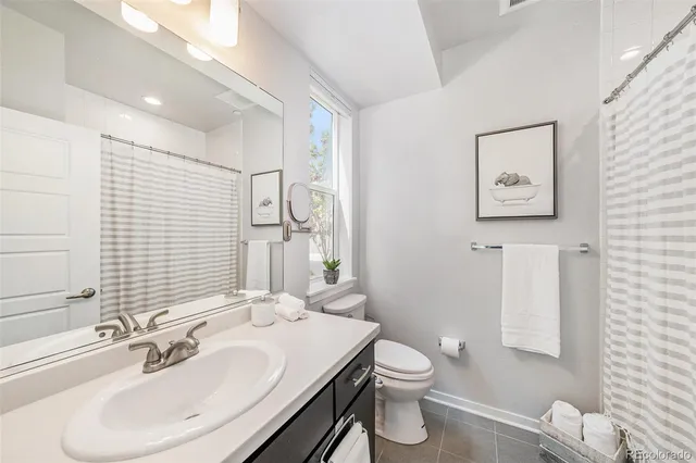 a large kitchen with stainless steel appliances a stove center island a counter space and a refrigerator