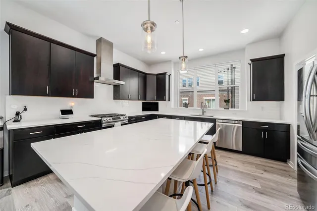 a bathroom with a granite countertop sink a toilet a mirror and shower