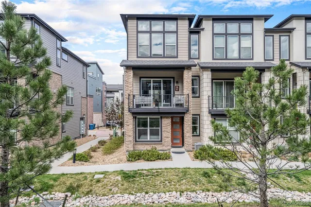 a living room with furniture kitchen view and a flat screen tv