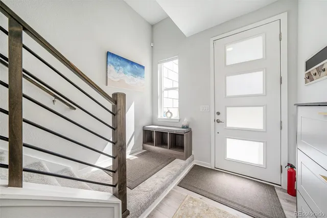 a kitchen with stainless steel appliances kitchen island granite countertop a sink refrigerator and cabinets