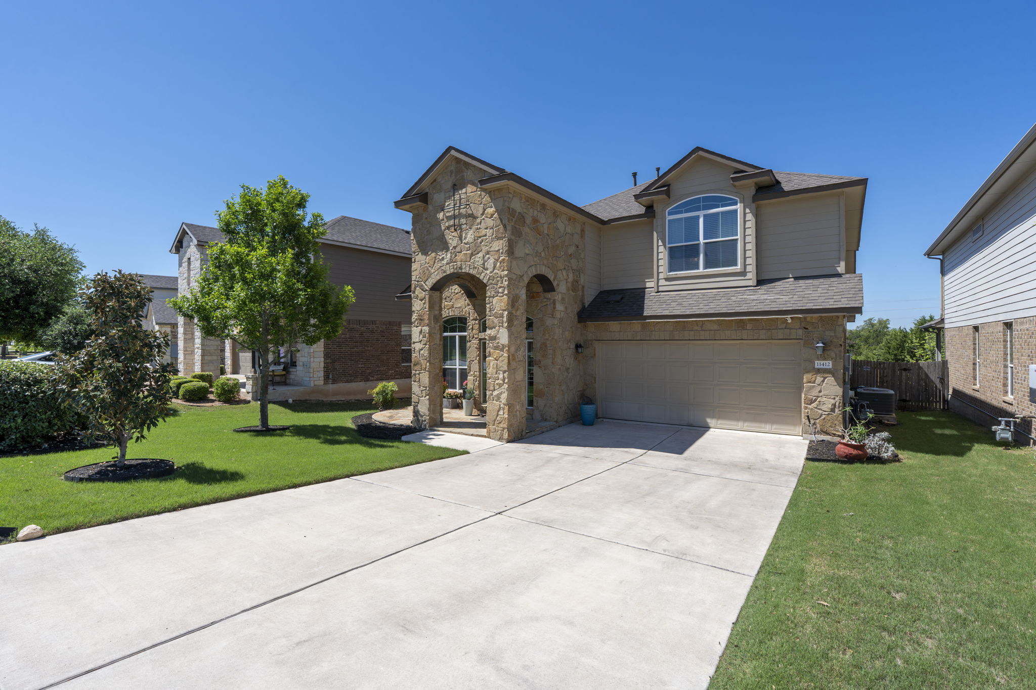 11412 Reading Way Austin, TX 78717 - Photo 3 of 35 a front view of a house with a yard and garage