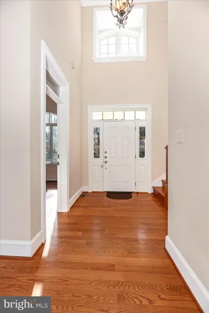 a view of entryway with wooden floor and stairs