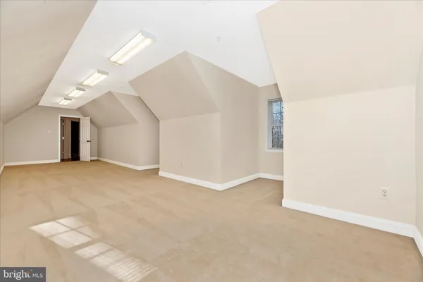 an empty room with closet and windows