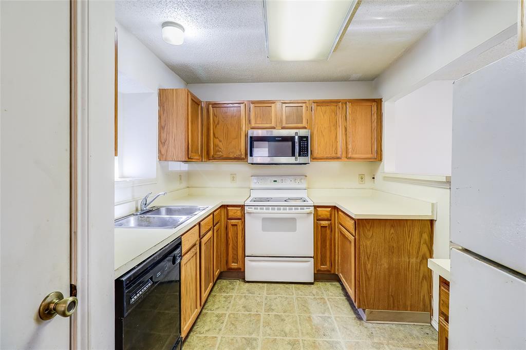 1728 Hackamore Street Mesquite, TX 75149 - Photo 9 of 22 a kitchen with a sink a stove and cabinets