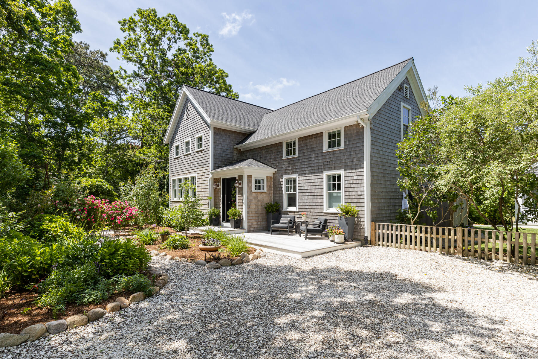 145 Henry's Road Brewster, MA 02631 - Photo 1 of 54 a front view of a house with yard and seating area