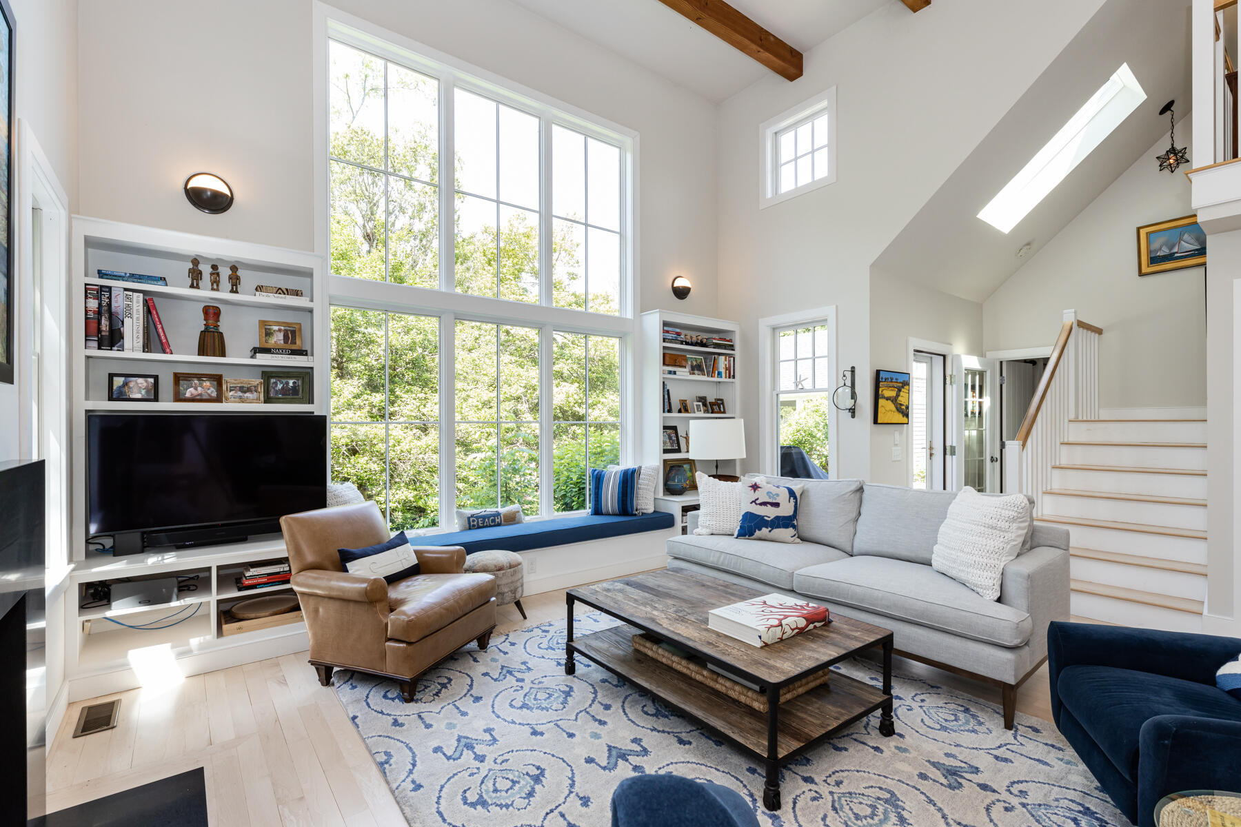 145 Henry's Road Brewster, MA 02631 - Photo 13 of 54 a living room with furniture a rug and a flat screen tv