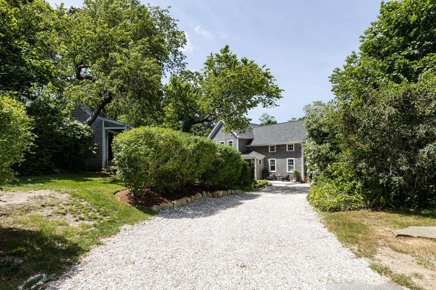 145 Henry's Road Brewster, MA 02631 - Photo 44 of 54 a front view of a house with a yard and garage