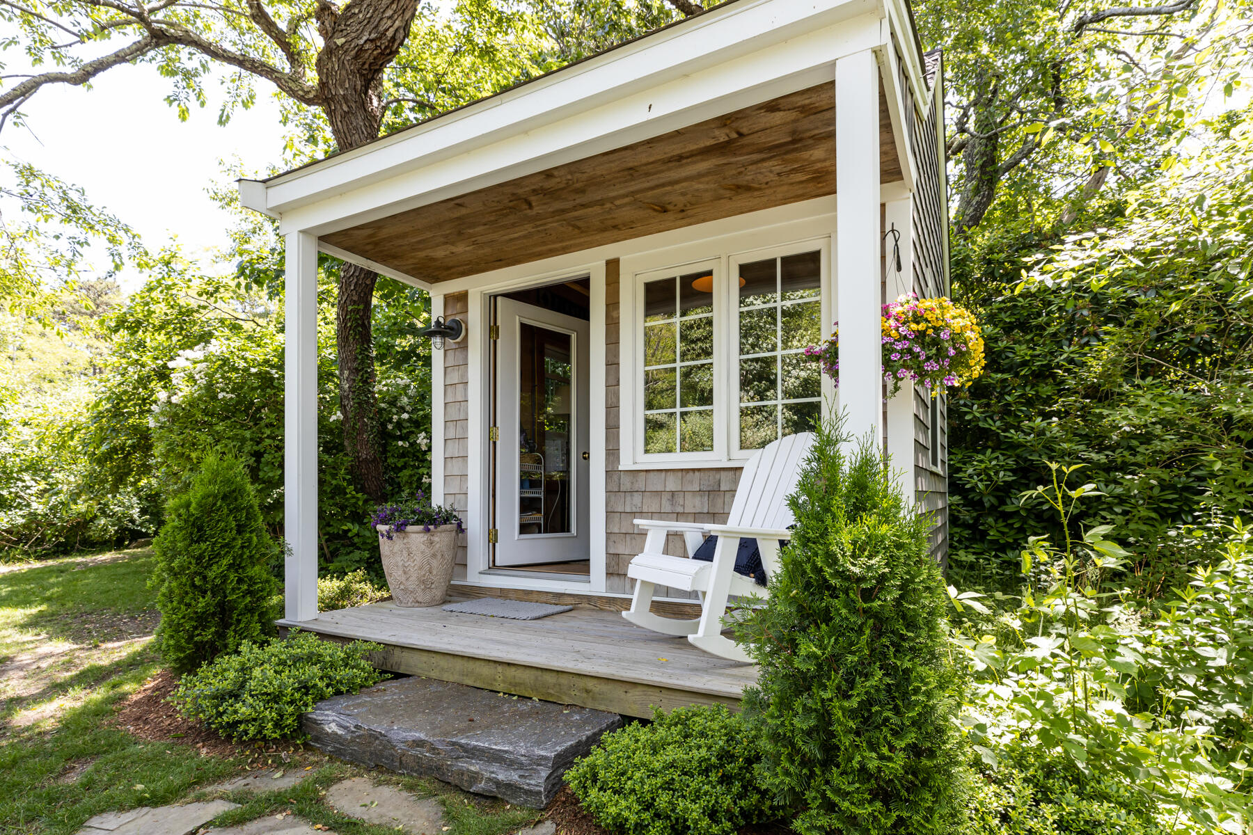 145 Henry's Road Brewster, MA 02631 - Photo 45 of 54 a view of a house with potted plants and a large tree