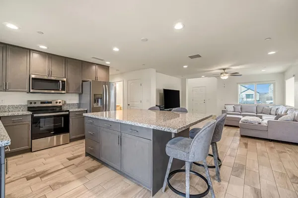 a kitchen with a sink stainless steel appliances and cabinets