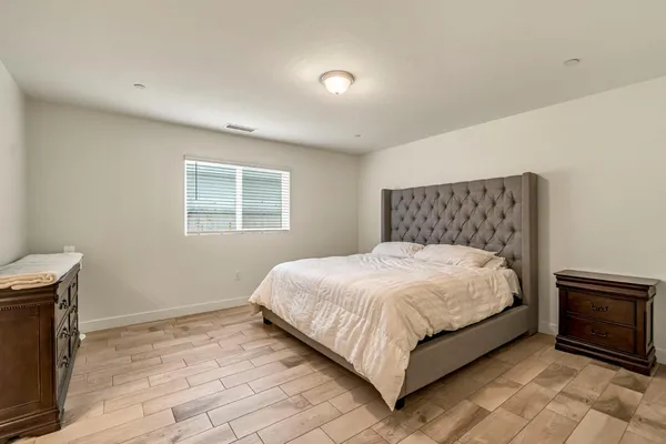 a bed sitting in a bedroom next to a window