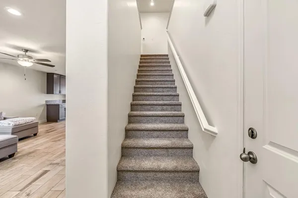 a view of entryway and hall with wooden floor